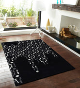 Modern artisan wool rug in black with cascading geometric design